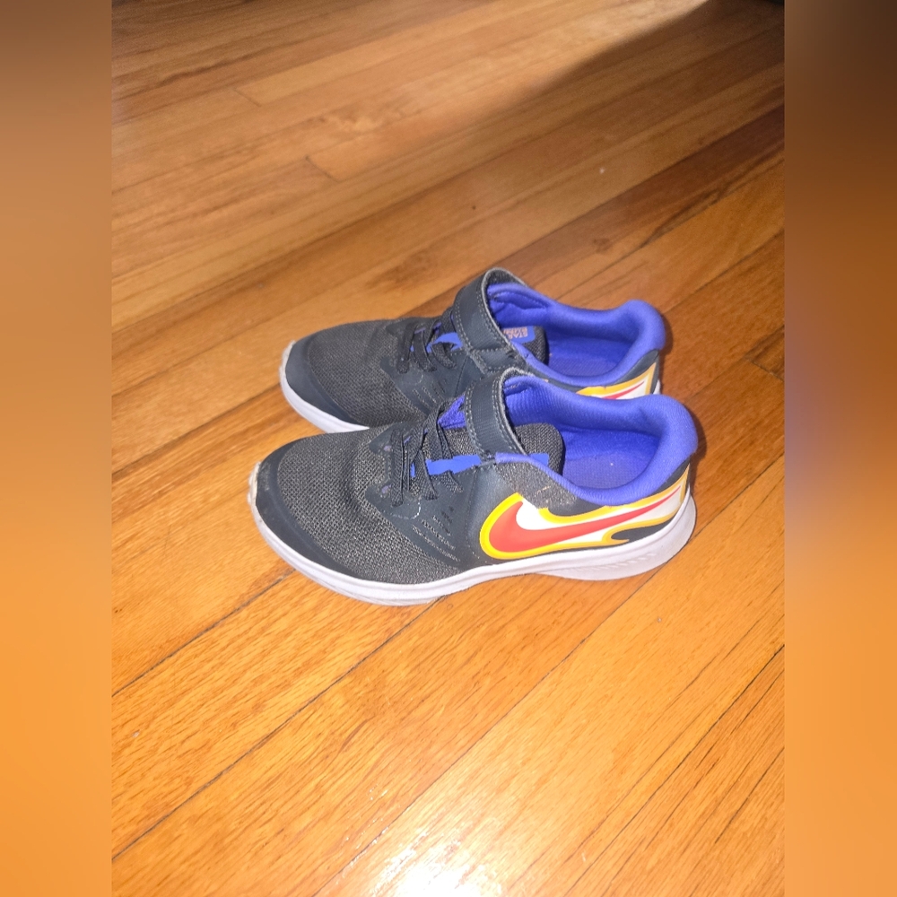 Nike Kids Black Sneakers with Blue Lining and Yellow/Red Swoosh